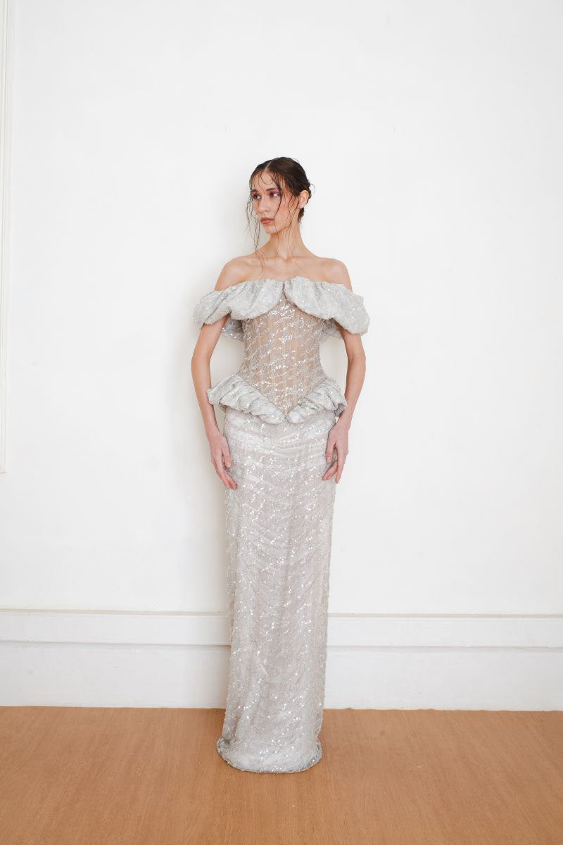 YASSMIN SALEH silver keepsake gown front view, elegant evening dress with intricate details and flowing fabric.
