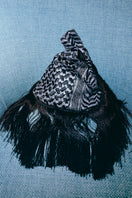 Black keffiyeh slip clutch bag with fringes by Sarah's Bag, featuring a textured anthracite design and stylish tassel accents.