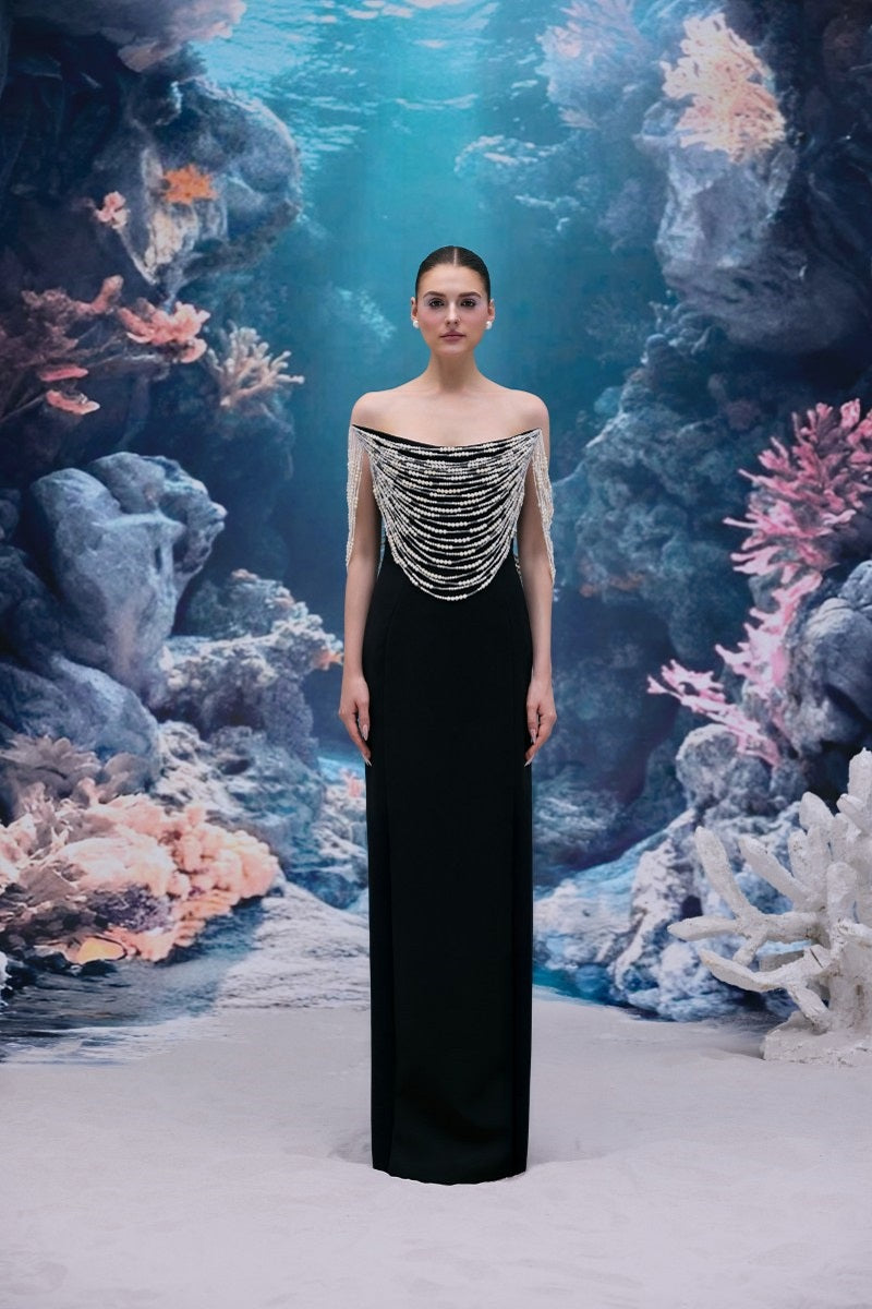 Black Noelle crepe gown by 21Six, featuring a flowing silhouette and elegant design, shown in a full-length image.