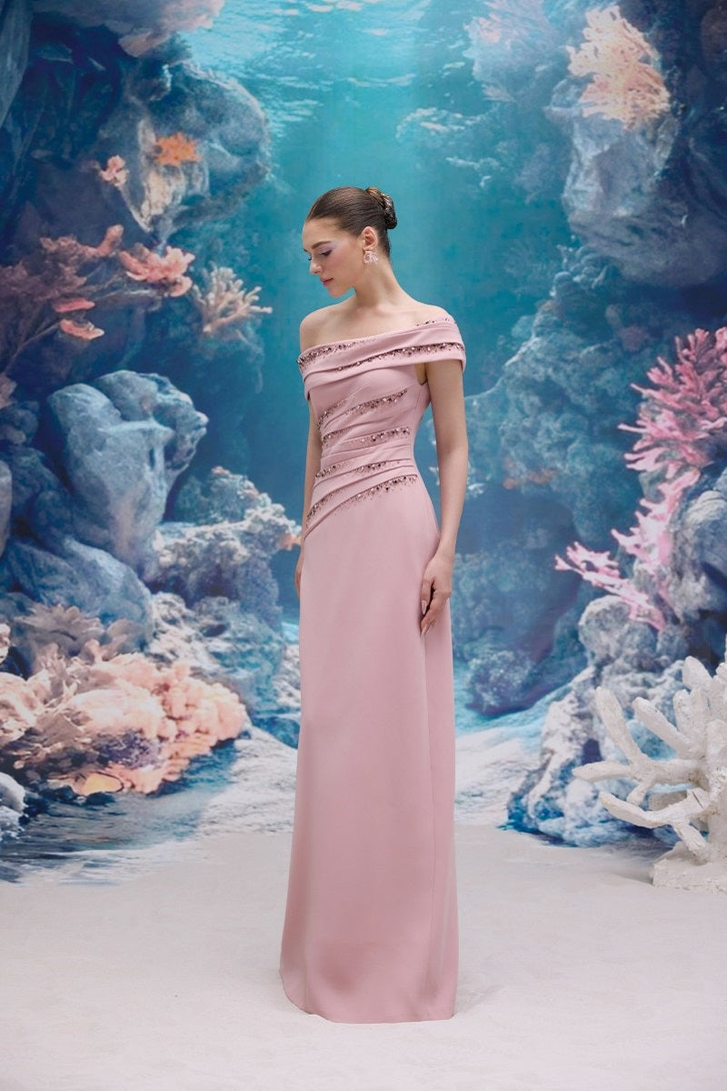 Light rose Nadine crepe gown by 21Six, featuring a flowy silhouette and elegant design, displayed on a mannequin.
