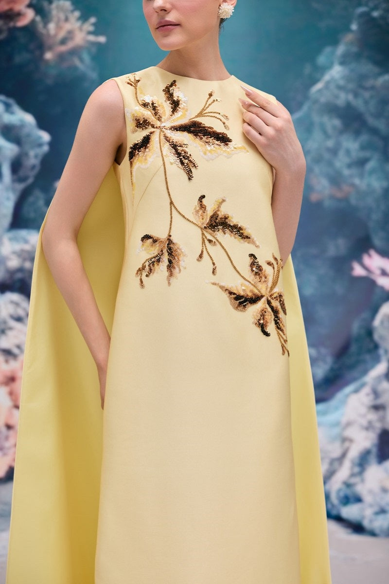Elegant pale yellow LYSANDRA royal taffeta gown by 21Six, showcasing its flowing fabric and intricate design details.