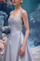 Elegant blue Sienna Royal Taffeta gown by 21Six, featuring a flowing design and intricate details, suited for formal occasions.
