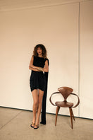 Black Kemmiye mini dress by Khanum's, shown on a model, featuring a sleek, fitted silhouette and stylish design.