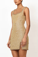 Kerri mini dress in gold by Khanum's, featuring a trendy sleeveless design, fitted silhouette, and stylish gold fabric.