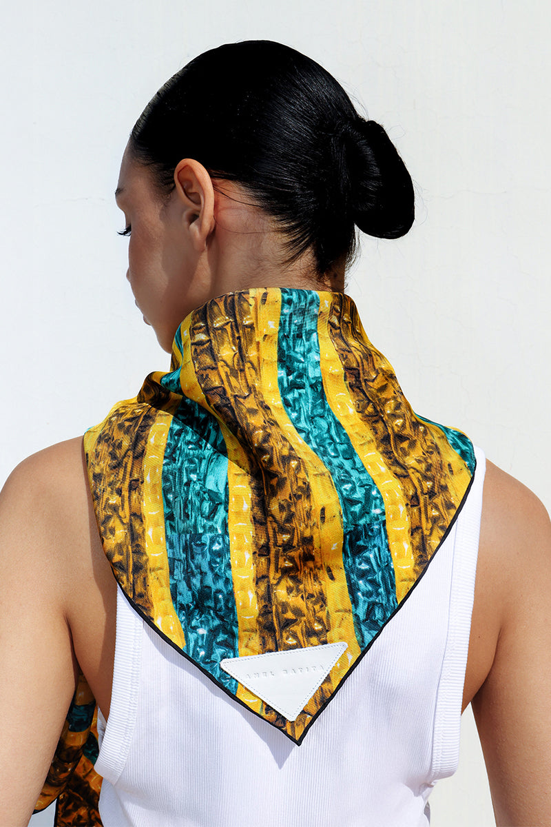 Amel Batita Khamon Brocot silk scarf featuring intricate traditional patterns, displayed draped at the back.