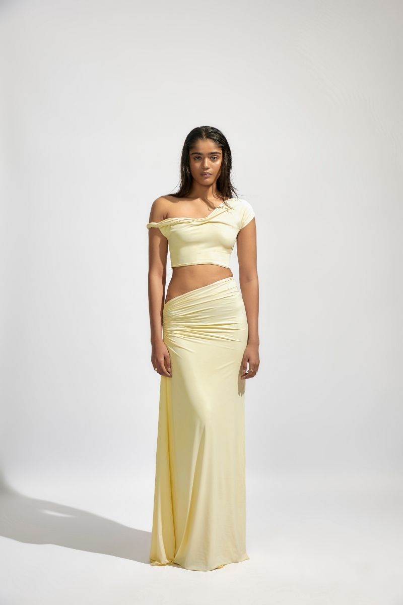 Deme By Gabriella KIRA butter yellow co-ord set featuring a fitted top and matching skirt, styled for a chic, coordinated look.