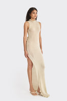 Beige knit low-back maxi dress by Stolen Stores displayed on a model, featuring a flowing silhouette and stylish back design.