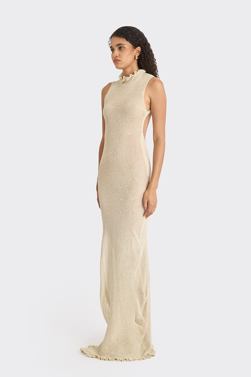 Beige knit low-back maxi dress from Stolen Stores, featuring a flowing silhouette and stylish slip design.