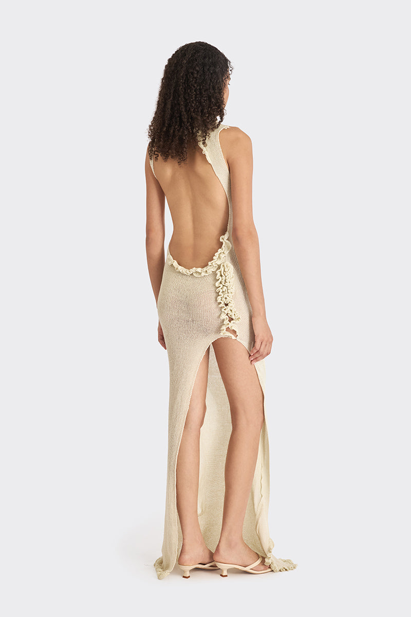 Beige knit low-back maxi dress by Stolen Stores featuring a flowing silhouette and slip design.