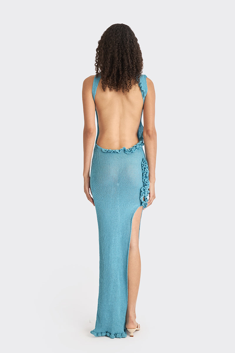 Blue knit low-back maxi dress by Stolen Stores, featuring a flowing silhouette and stylish slip design perfect for casual or evening wear.