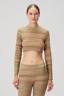 Striped knit crop top by Bassigue featuring a fitted design and long sleeves, styled with casual fashion.
