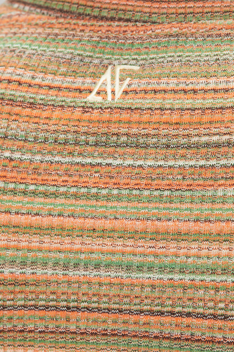 Striped knit crop top by Bassigue, featuring a fitted design and stylish pattern, perfect for casual or trendy outfits.