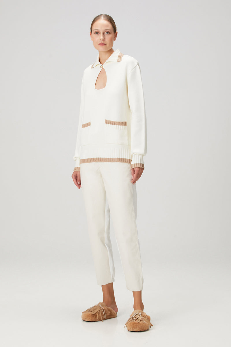 White knit sweater with pocket detailing by Bassigue, featuring a cozy, textured design perfect for casual wear.