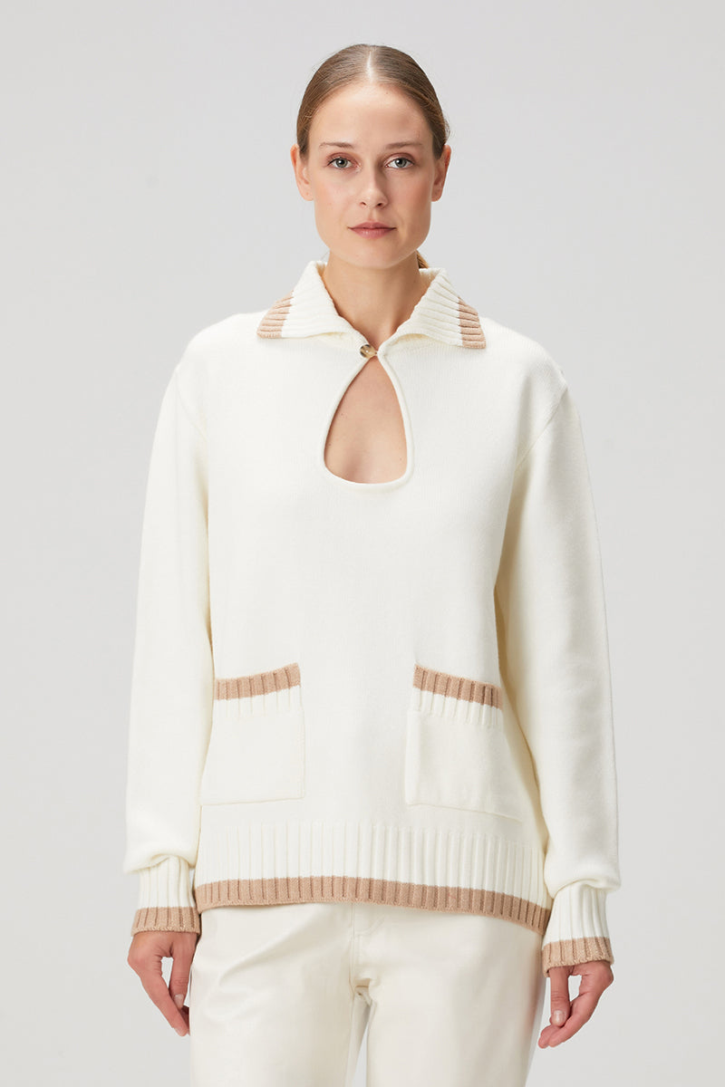 White knit sweater with pocket detailing from Bassigue, featuring a cozy, textured fabric and a stylish, casual fit.