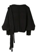 Black knitted sweater with long braids from MAZ Manuela Álvarez, featuring a cozy, textured knit design for stylish warmth.