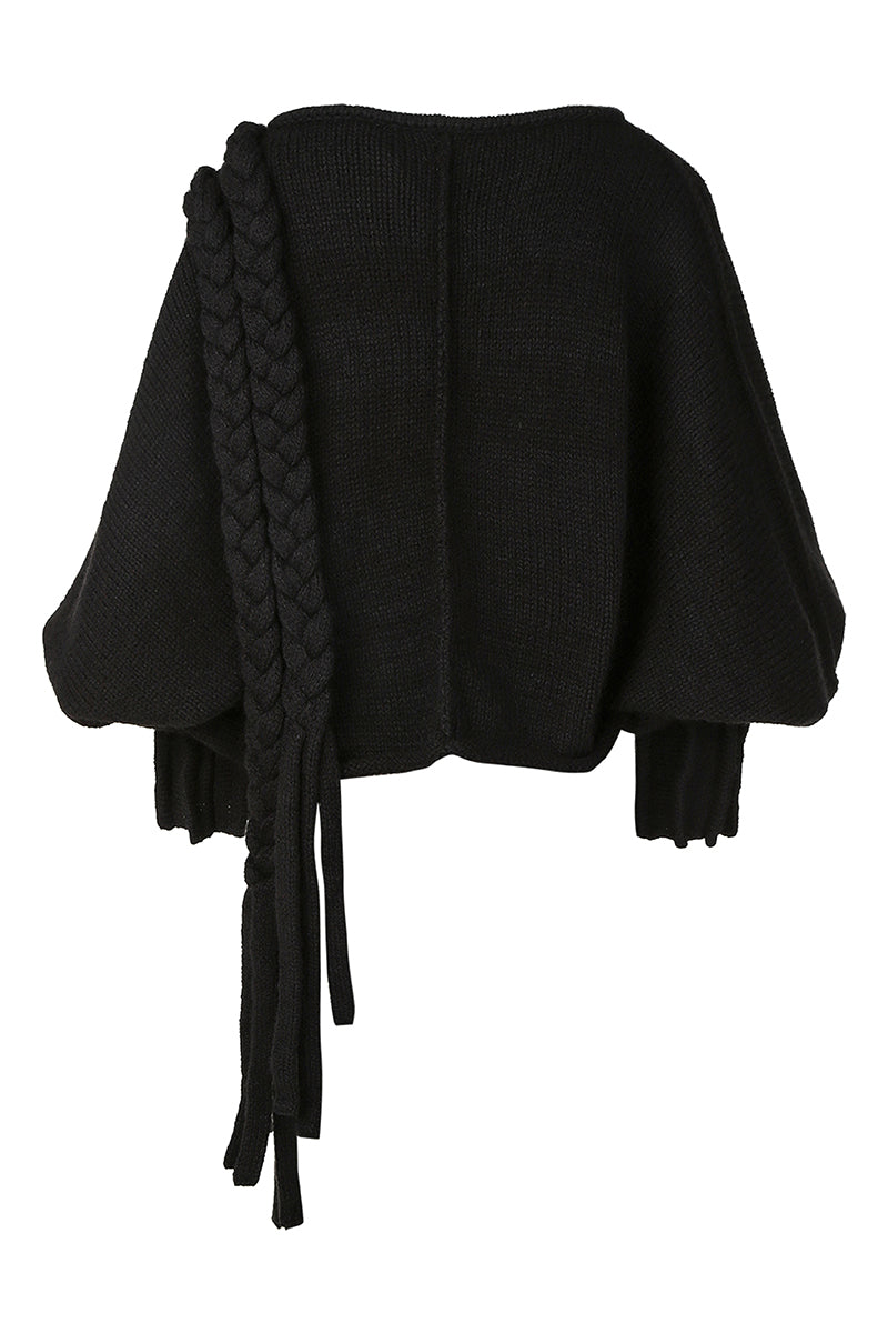 Black knitted sweater with long braids from MAZ Manuela Álvarez, featuring a cozy, textured knit design for stylish warmth.
