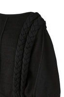 Black knitted sweater with long braids from MAZ Manuela Álvarez, featuring a cozy, stylish design perfect for casual wear.