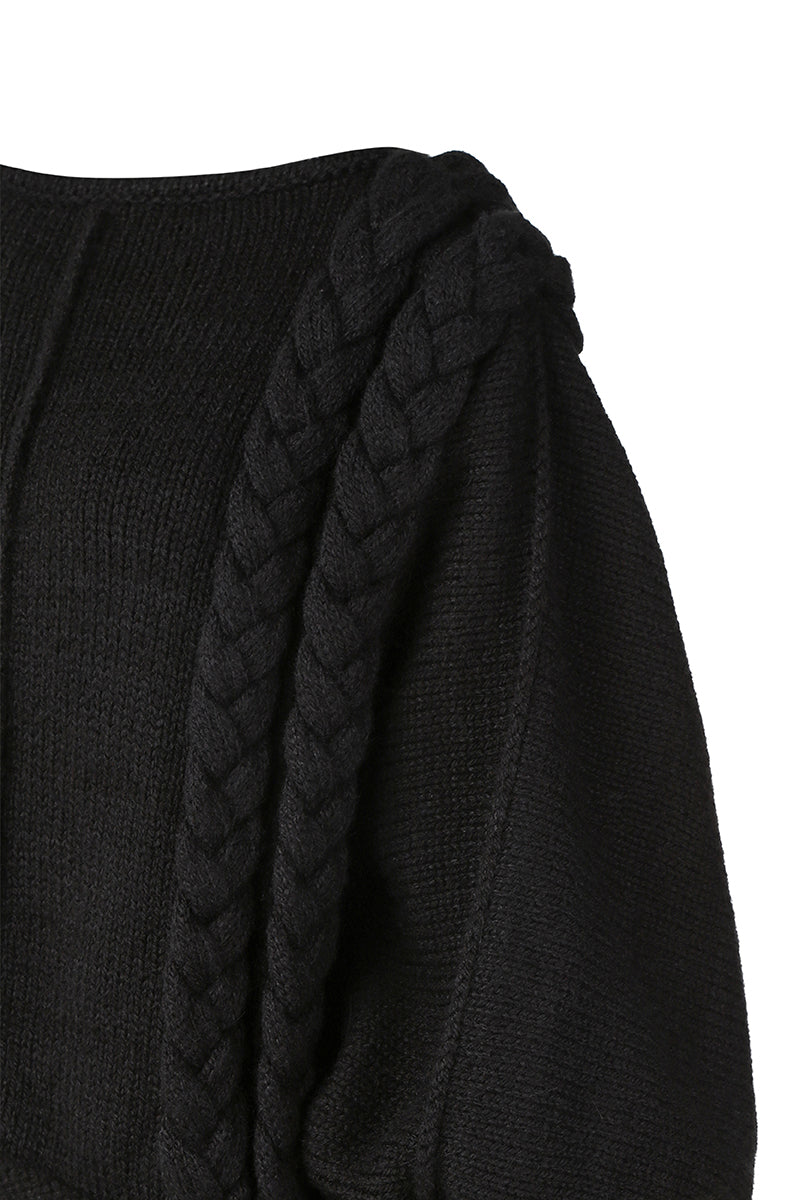 Black knitted sweater with long braids from MAZ Manuela Álvarez, featuring a cozy, stylish design perfect for casual wear.