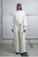 Ivory knitted sweater with long braids from MAZ Manuela Álvarez, cozy and stylish long-sleeve sweater for women.