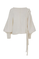Ivory knitted sweater with long braided details from MAZ Manuela Álvarez, cozy and stylish for casual wear.