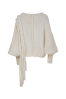 Ivory knitted sweater with long braids by MAZ Manuela Álvarez, featuring a cozy, textured design and long braided accents.