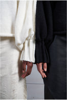 Ivory knitted sweater with long braids by MAZ Manuela Álvarez, cozy and stylish long-sleeve sweater for women.