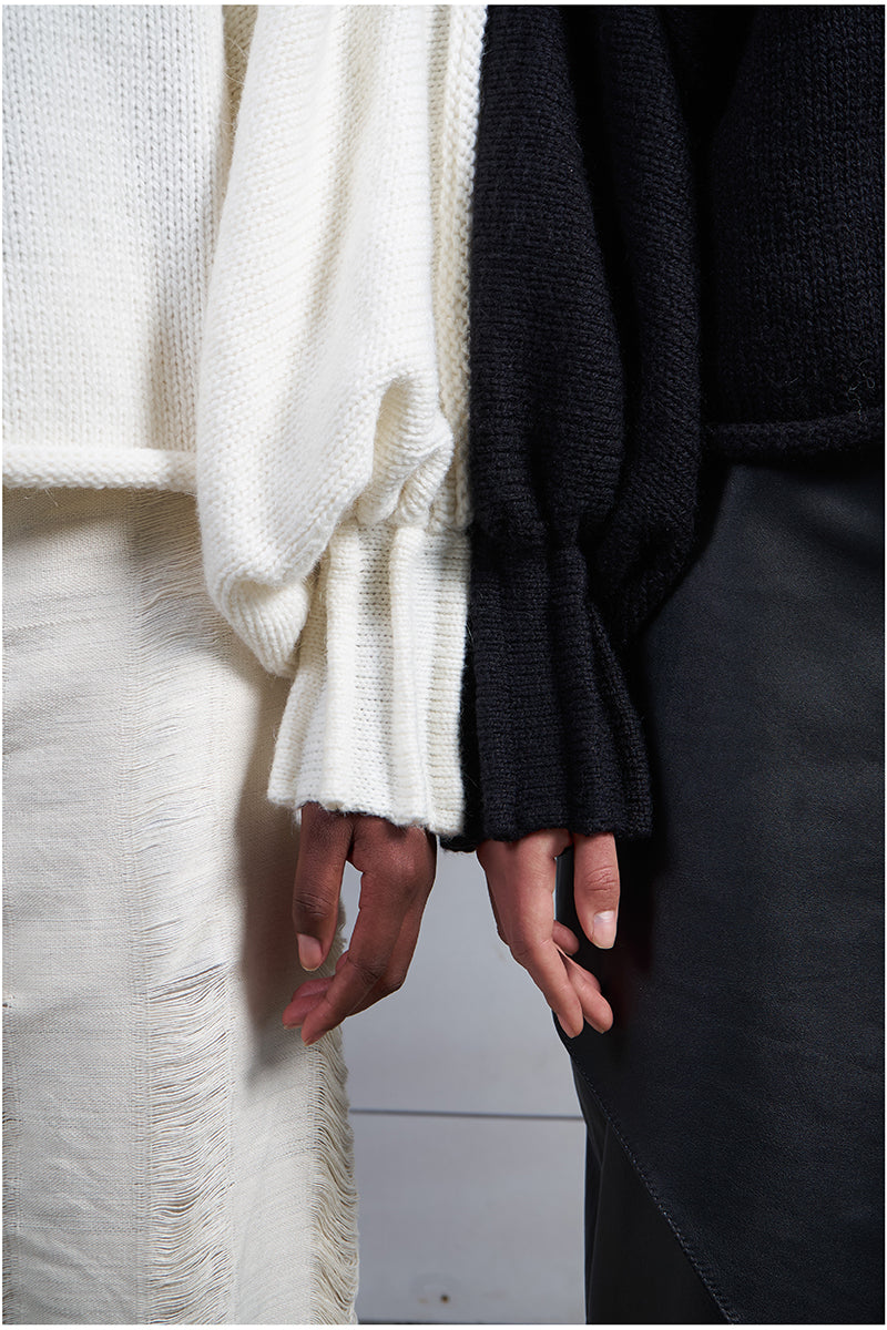 Ivory knitted sweater with long braids by MAZ Manuela Álvarez, cozy and stylish long-sleeve sweater for women.