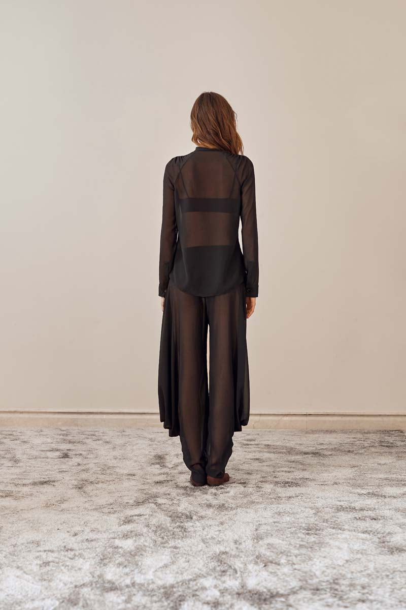 Back view of YASSMIN SALEH black knot pants featuring a stylish knot detail and relaxed fit.