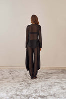 Black YASSMIN SALEH knot top featuring a stylish front knot and a relaxed fit, shown from the back view.