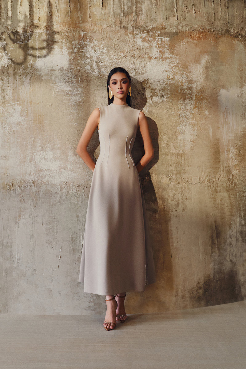 L'SCARLETT sleeveless flared midi dress shown, featuring a fitted bodice and flowing skirt in a stylish design.