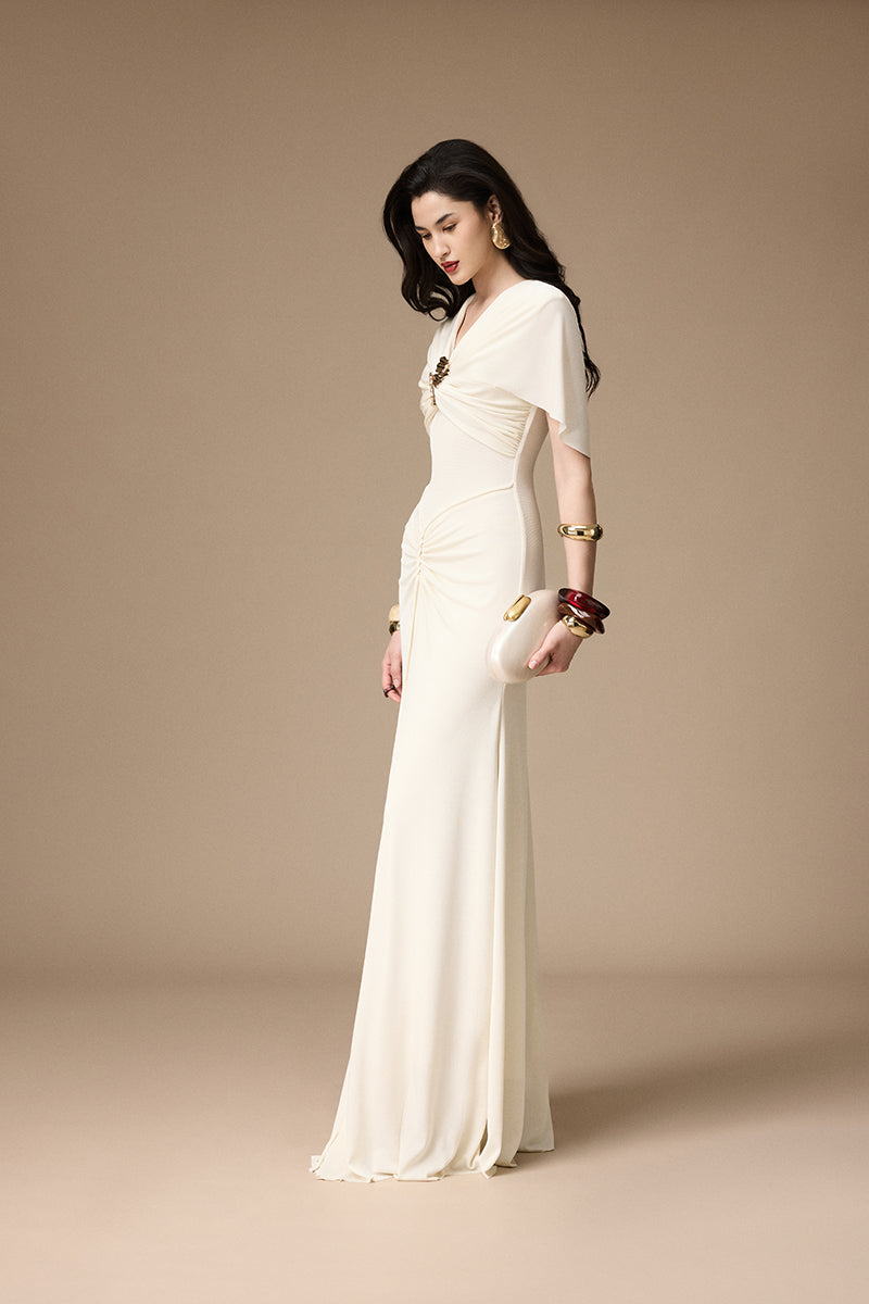 Elegant ivory gown by Jenny K Tran featuring intricate details, perfect for formal occasions.