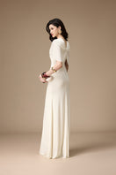 Jenny K Tran ivory gown featuring elegant lace and flowing fabric, perfect for formal occasions.