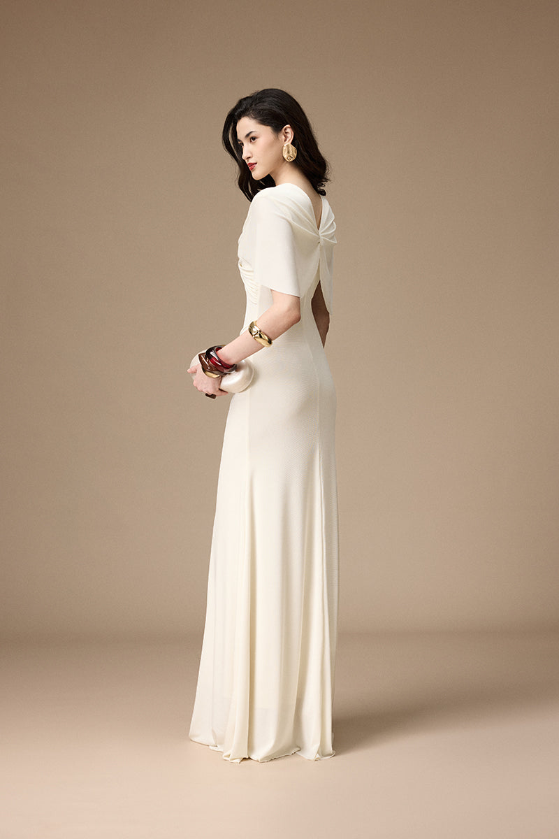 Jenny K Tran ivory gown featuring elegant lace and flowing fabric, perfect for formal occasions.