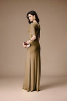 Elegant khaki gown by Jenny K Tran from the La Perla collection, featuring flowing fabric and intricate detailing.