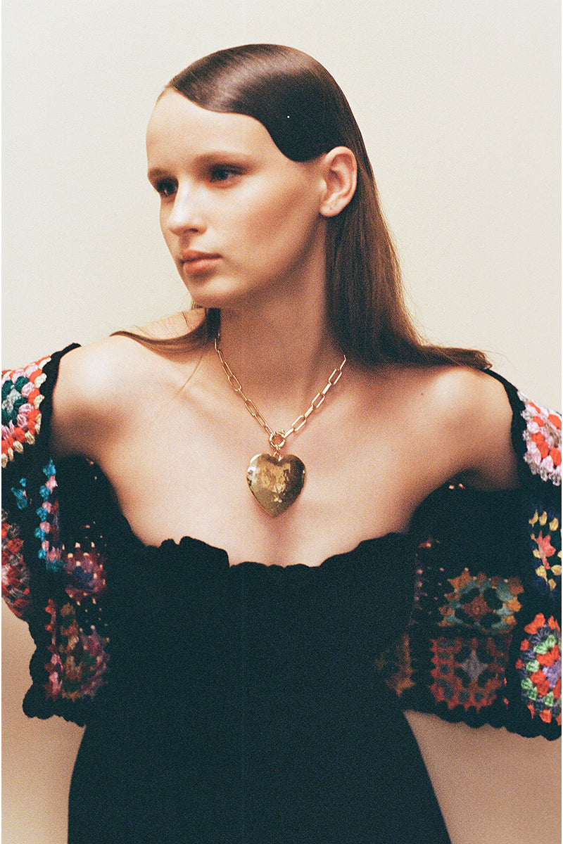 Gold Larva Necklace by Jessica K featuring a delicate larva pendant on a fine chain.