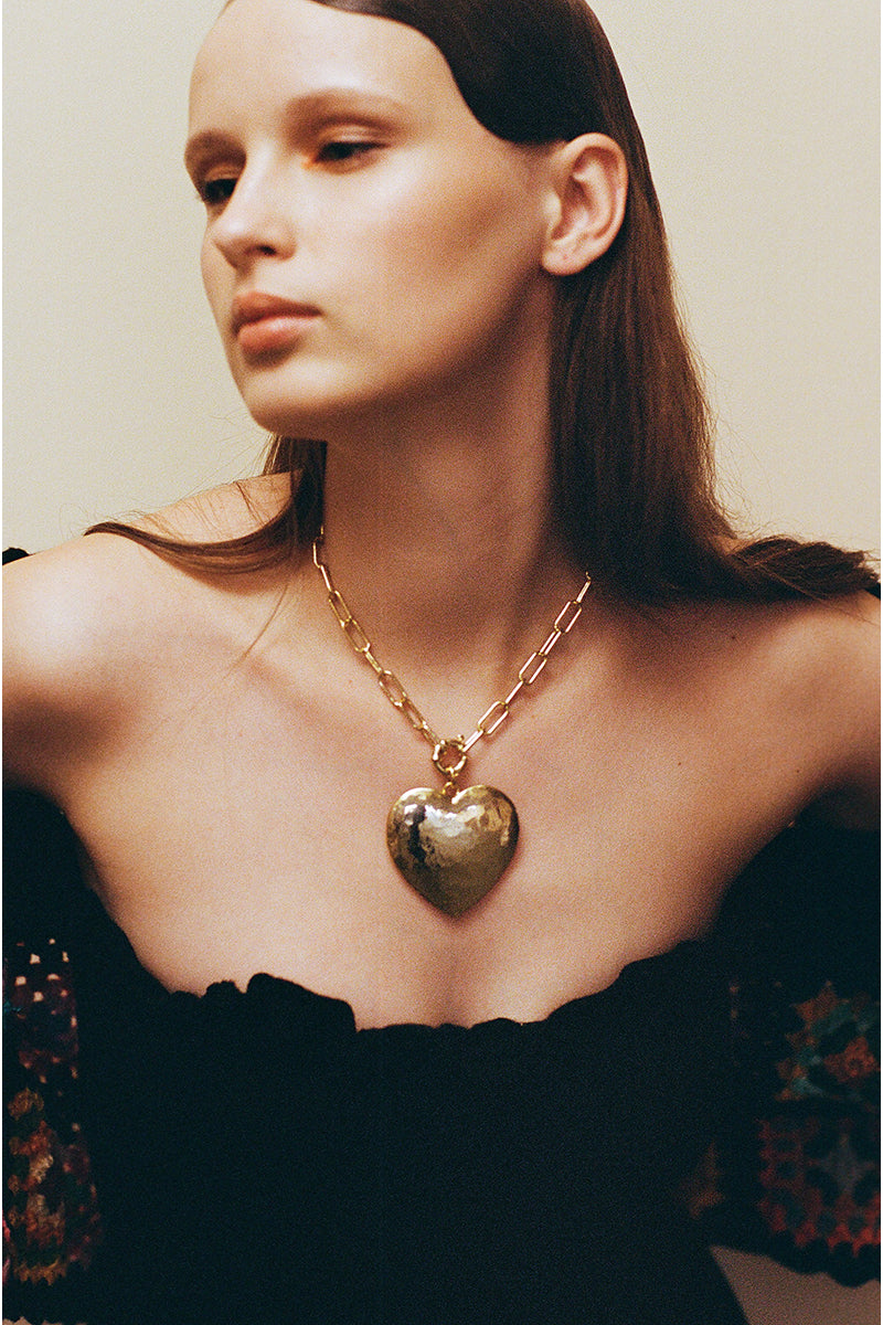 Gold Larva Necklace by Jessica K featuring a sleek, modern design with a delicate chain and larva-shaped pendant.