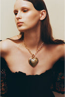 Gold Larva Necklace by Jessica K featuring a sleek, modern design with a delicate chain and larva-shaped pendant.
