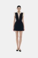 Black ruffle V-neck mini dress by Montsand, featuring a stylish mini dress design with ruffle details and V-neck neckline.