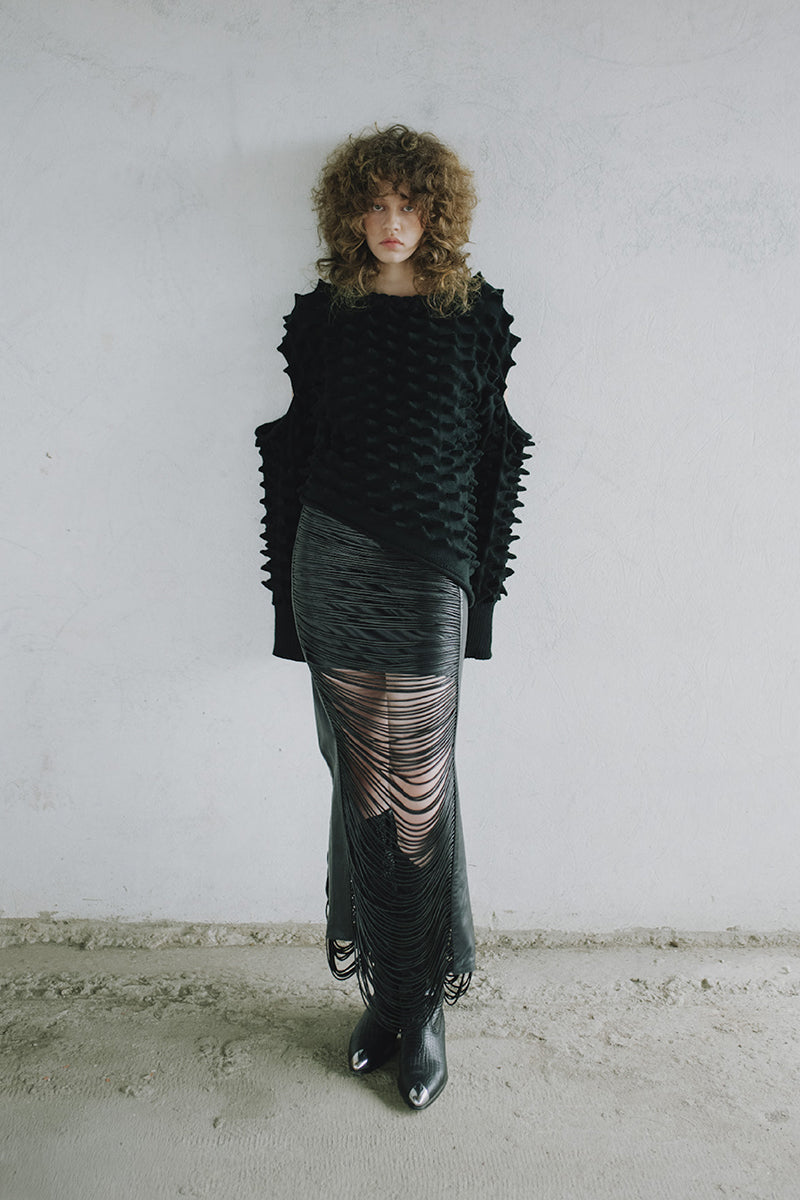 Black leather snake-like cord maxi skirt by MAZ Manuela Álvarez, featuring a sleek, flowing design and unique textured details.