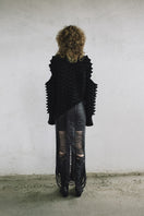 Black leather snake-like cord maxi skirt by MAZ Manuela Álvarez, featuring a sleek, form-fitting design and textured snake pattern.