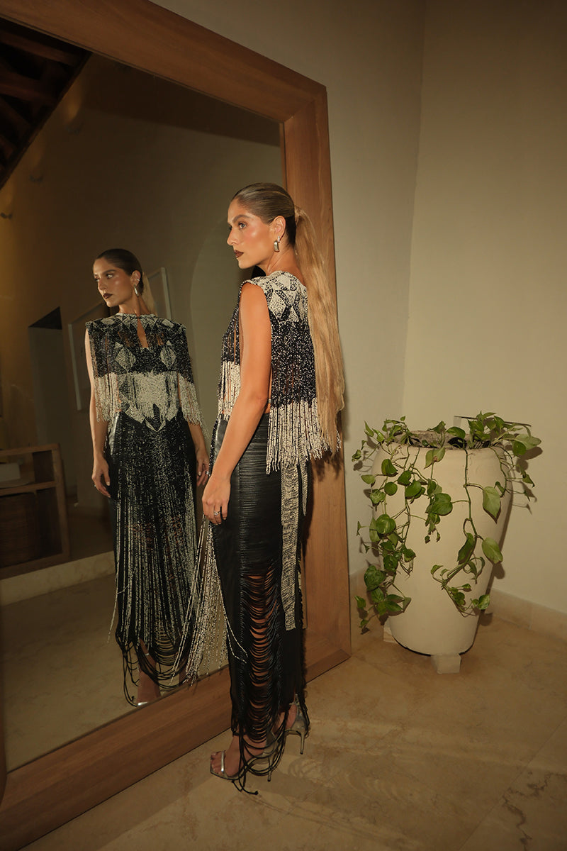 Black leather snake-like cord maxi skirt by MAZ Manuela Álvarez, featuring a flowing, elongated silhouette and stylish design.