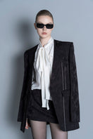 Black LEKIEU Amiens mini skirt with a fitted waist and smooth fabric, styled for a chic, casual look.