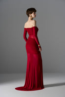 Elegant crimson Aphrodite gown by Le Thanh Hoa featuring flowing fabric and intricate design details.