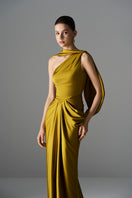Golden Goddess gown by Le Thanh Hoa, elegant evening dress with flowing fabric and intricate details, shown on a model.