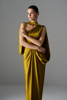 Elegant golden goddess gown by Le Thanh Hoa featuring flowing fabric and intricate detailing perfect for formal occasions.