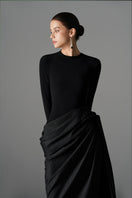 Elegant Le Thanh Hoa Serpentine Chic gown with flowing fabric and intricate design, perfect for formal occasions.