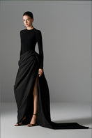 Elegant Le Thanh Hoa Serpentine Chic gown with flowing fabric and intricate detailing, perfect for formal occasions.
