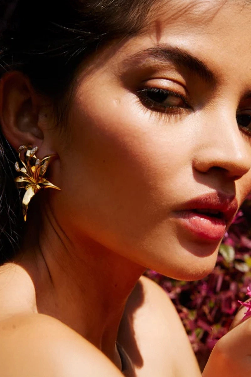 White Lily crystal earrings by PERACAS featuring sparkling Swarovski crystals and elegant floral design.