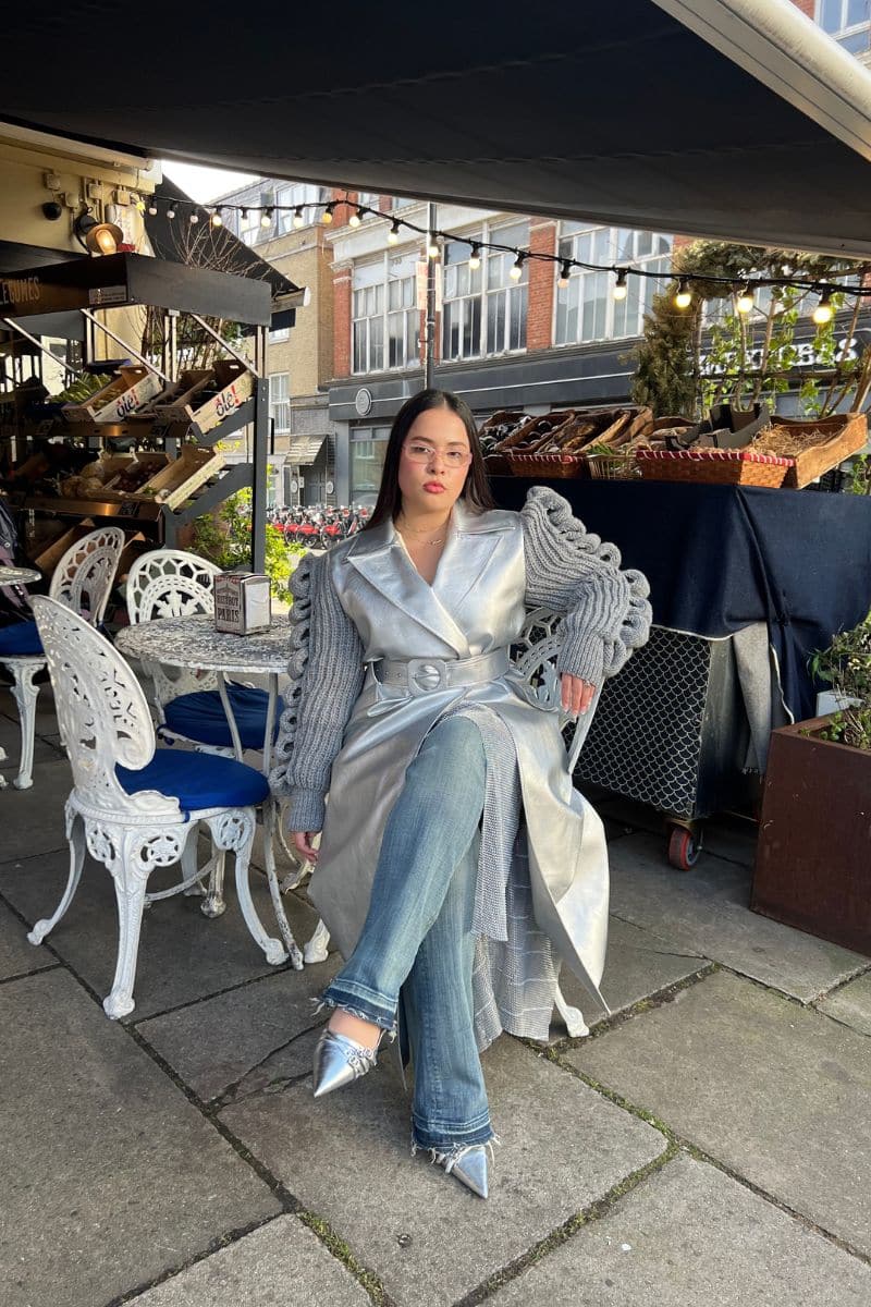 Liya CULT MIA X LIYA disco trench coat in shiny fabric with a tailored fit and stylish lapel collar, displayed on a hanger.