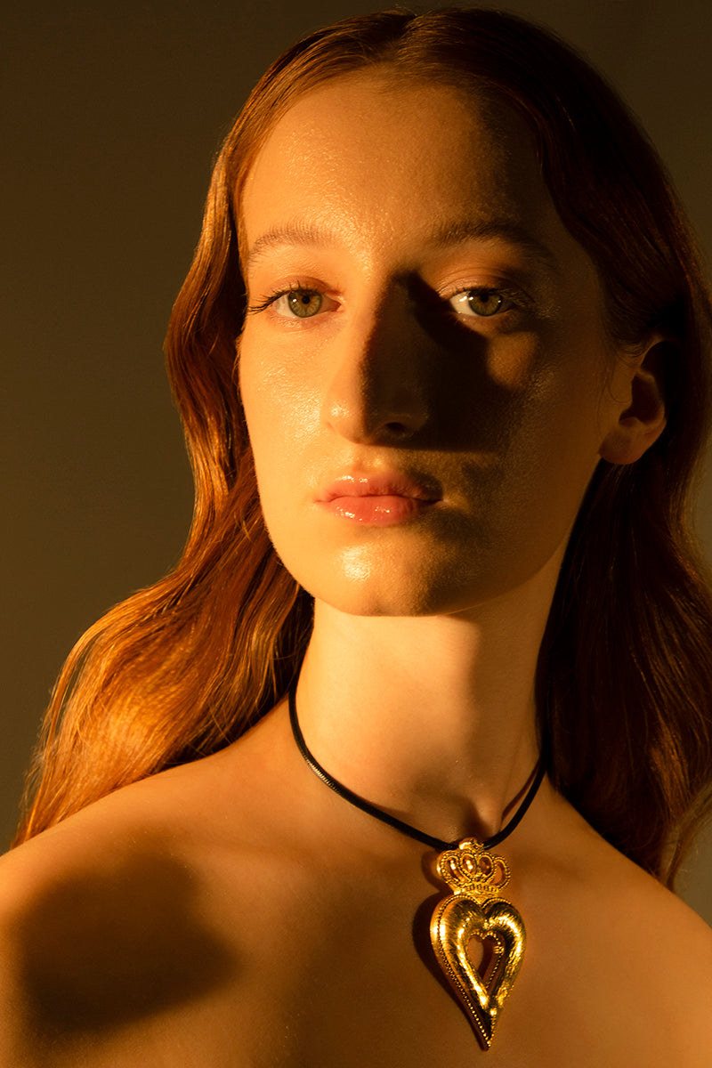 Gold crowned heart necklace by Natia x Lako featuring a delicate pendant on a fine chain, stylish jewelry for special occasions.